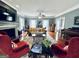 Large, well-lit living room with wood floors, fireplace, and comfortable seating at 114 Rolling Grn, Peachtree City, GA 30269