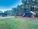 A large playground with slides, climbing structures, and a picnic area nestled in a wooded area at 114 Rolling Grn, Peachtree City, GA 30269