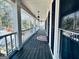 Inviting front porch with classic columns, black shutters, and lovely landscaping along the walkway at 114 Rolling Grn, Peachtree City, GA 30269