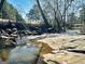Beautiful creek with rocky details enhancing the landscape at 114 Rolling Grn, Peachtree City, GA 30269