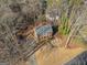 Aerial view of a traditional brick home with a long driveway, nestled among trees in a quiet neighborhood at 505 Summer Ter, Woodstock, GA 30189