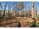 Back deck features railing, views of trees and fenced backyard at 505 Summer Ter, Woodstock, GA 30189