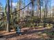 Backyard view of swing and slide set with wooded views at 505 Summer Ter, Woodstock, GA 30189