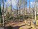 The backyard includes a wood deck and wooded views at 505 Summer Ter, Woodstock, GA 30189