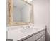 Bathroom vanity featuring a decorative mirror, white countertop, and modern faucet at 505 Summer Ter, Woodstock, GA 30189