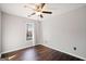 Bedroom featuring hardwood floors, ceiling fan and a large window with natural light at 505 Summer Ter, Woodstock, GA 30189