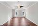 Bedroom with a tray ceiling, neutral walls, wood floor and two windows at 505 Summer Ter, Woodstock, GA 30189