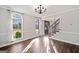 Elegant dining room with hardwood floors, chandelier, and large windows at 505 Summer Ter, Woodstock, GA 30189