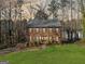 Charming two-story brick home featuring blue shutters and lush landscaping at 505 Summer Ter, Woodstock, GA 30189
