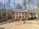 Charming two-story brick home featuring blue shutters and lush landscaping at 505 Summer Ter, Woodstock, GA 30189
