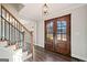 Inviting foyer featuring hardwood floors, stairs, and a front door with glass panes at 505 Summer Ter, Woodstock, GA 30189