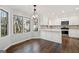 Eat-in kitchen with white cabinets, stainless steel appliances, and large windows at 505 Summer Ter, Woodstock, GA 30189