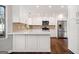 Modern kitchen featuring stainless steel appliances, white cabinets, and a breakfast bar at 505 Summer Ter, Woodstock, GA 30189