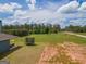 Backyard view featuring trampoline and a blue house in the distance at 296 Beavers Rd, Grantville, GA 30220