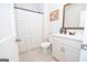 Well-lit bathroom with a white vanity, framed mirror, and tiled floor with bath and shower at 296 Beavers Rd, Grantville, GA 30220