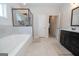 Bathroom with a glass-enclosed shower, tub, and double vanity at 296 Beavers Rd, Grantville, GA 30220