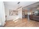 Open dining area showcasing wood-look flooring, a chandelier, and view into the kitchen at 296 Beavers Rd, Grantville, GA 30220