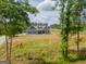 Secluded two-story home with blue siding and black shutters, framed by lush trees at 296 Beavers Rd, Grantville, GA 30220