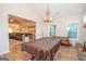 Spacious game room with billiard table, antler chandelier, and windows for natural light at 296 Beavers Rd, Grantville, GA 30220