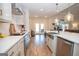 View of the contemporary kitchen showcasing a white countertop, modern appliances, and wood flooring at 296 Beavers Rd, Grantville, GA 30220