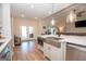 Kitchen island featuring a sink, microwave, modern countertops, and white cabinets offers a bright and airy atmosphere at 296 Beavers Rd, Grantville, GA 30220