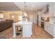 Bright kitchen featuring an island with seating, stainless steel appliances, and an open layout at 296 Beavers Rd, Grantville, GA 30220