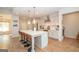 Modern kitchen with a large island, white cabinets, stainless steel appliances, and pendant lighting at 296 Beavers Rd, Grantville, GA 30220