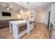 Modern kitchen boasts an island with stainless steel microwave and sink, complemented by wood flooring at 296 Beavers Rd, Grantville, GA 30220