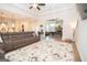 Spacious living room featuring a cozy sofa, decorative rug, and fireplace beyond at 296 Beavers Rd, Grantville, GA 30220
