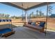 Relaxing porch with a swing, seating area and a view of the backyard at 296 Beavers Rd, Grantville, GA 30220
