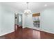 Inviting dining room with hardwood floors, a chandelier, and a view of the outdoors through the window at 101 Saddlebrook Dr, Peachtree City, GA 30269