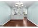 Bright dining area featuring hardwood floors, modern chandelier, and a view into the updated kitchen at 101 Saddlebrook Dr, Peachtree City, GA 30269