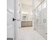 The pristine bathroom features marble tiling, a glass enclosed shower and white vanity at 114 Village Green Ave, Woodstock, GA 30189