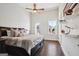 Bedroom with dark wood floors, ceiling fan, ample natural light, and stylish decor at 114 Village Green Ave, Woodstock, GA 30189