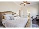 The bedroom has a luxurious, upholstered bed, neutral decor and adjoins the bathroom at 114 Village Green Ave, Woodstock, GA 30189