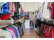 This is a spacious walk-in closet with custom shelving and clothing racks at 114 Village Green Ave, Woodstock, GA 30189