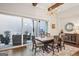 Elegant dining room with a large window, chandelier, and access to the outdoor patio at 114 Village Green Ave, Woodstock, GA 30189
