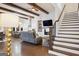 Inviting living room with hardwood floors, beamed ceilings, and a cozy fireplace at 114 Village Green Ave, Woodstock, GA 30189