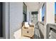 Relaxing front porch with white brick, comfortable seating and natural light at 114 Village Green Ave, Woodstock, GA 30189
