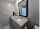 Bathroom featuring a modern sink with granite countertop and a stylish mirror at 5447 Ahyoka Dr, Morrow, GA 30260