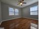 Bedroom featuring hardwood floors and two windows, providing ample natural light at 5447 Ahyoka Dr, Morrow, GA 30260