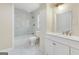 Bright bathroom with marble tile, a shower-tub combo, and a double sink vanity offers a spa-like experience at 2589B Se Fieldstone View Ln, Conyers, GA 30013