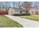 Traditional home with a spacious driveway surrounded by a well-maintained lawn and mature trees at 2589B Se Fieldstone View Ln, Conyers, GA 30013