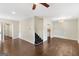 Spacious living room with hardwood floors, a ceiling fan, and staircase at 2589B Se Fieldstone View Ln, Conyers, GA 30013