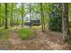 Exterior of a two-story home featuring a deck and surrounded by mature trees in a private backyard at 125 Marilyn Ct, Fayetteville, GA 30214