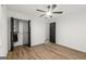 Cozy bedroom features sleek floors, open closet and ceiling fan creating a relaxing atmosphere at 125 Marilyn Ct, Fayetteville, GA 30214