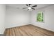 Bright bedroom features new floors, ceiling fan and a window providing ample natural light at 125 Marilyn Ct, Fayetteville, GA 30214