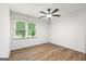 Sunlit bedroom boasts great flooring, ceiling fan and a window offering scenic views at 125 Marilyn Ct, Fayetteville, GA 30214
