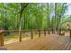 Large wooden deck with wood and wire railing, offering serene views of the beautiful wooded backyard at 125 Marilyn Ct, Fayetteville, GA 30214