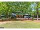 Charming two-story home with a well-manicured lawn and mature trees at 125 Marilyn Ct, Fayetteville, GA 30214